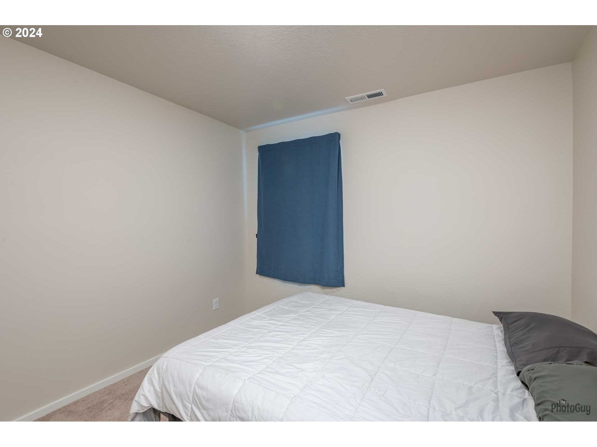 2661 26th Loop Springfield, OR 97477 - Photo 35 of 43 a bedroom with a bed and a wall painting