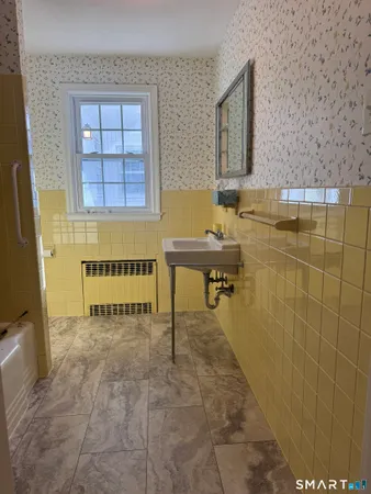 a bathroom with a sink a mirror and a bathtub