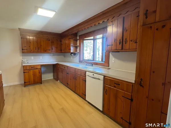 a kitchen with stainless steel appliances granite countertop a sink and cabinets