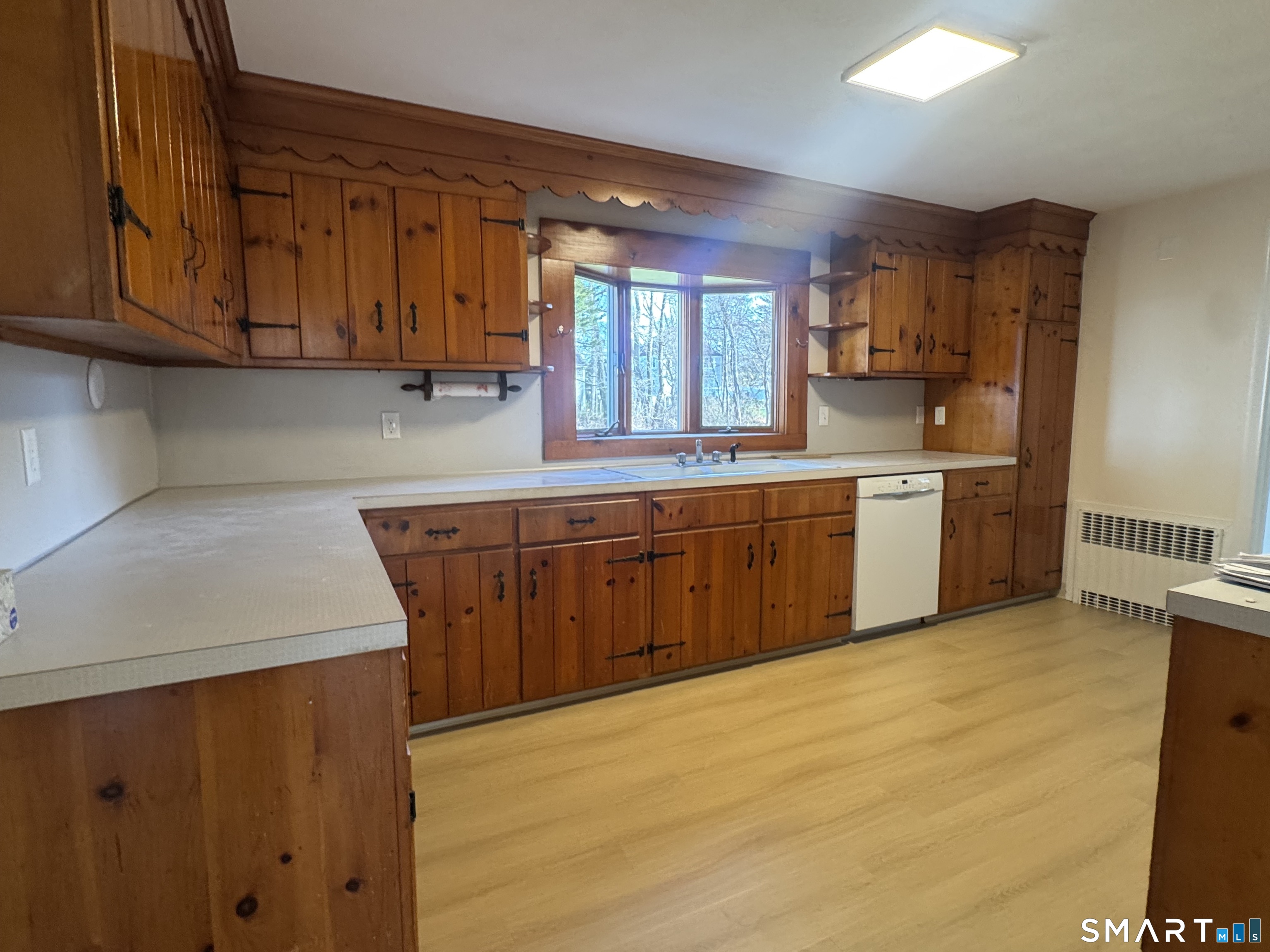 31 Pawson Road Branford, CT 06405 - Photo 7 of 13 a kitchen with stainless steel appliances granite countertop a sink and cabinets with wooden floor
