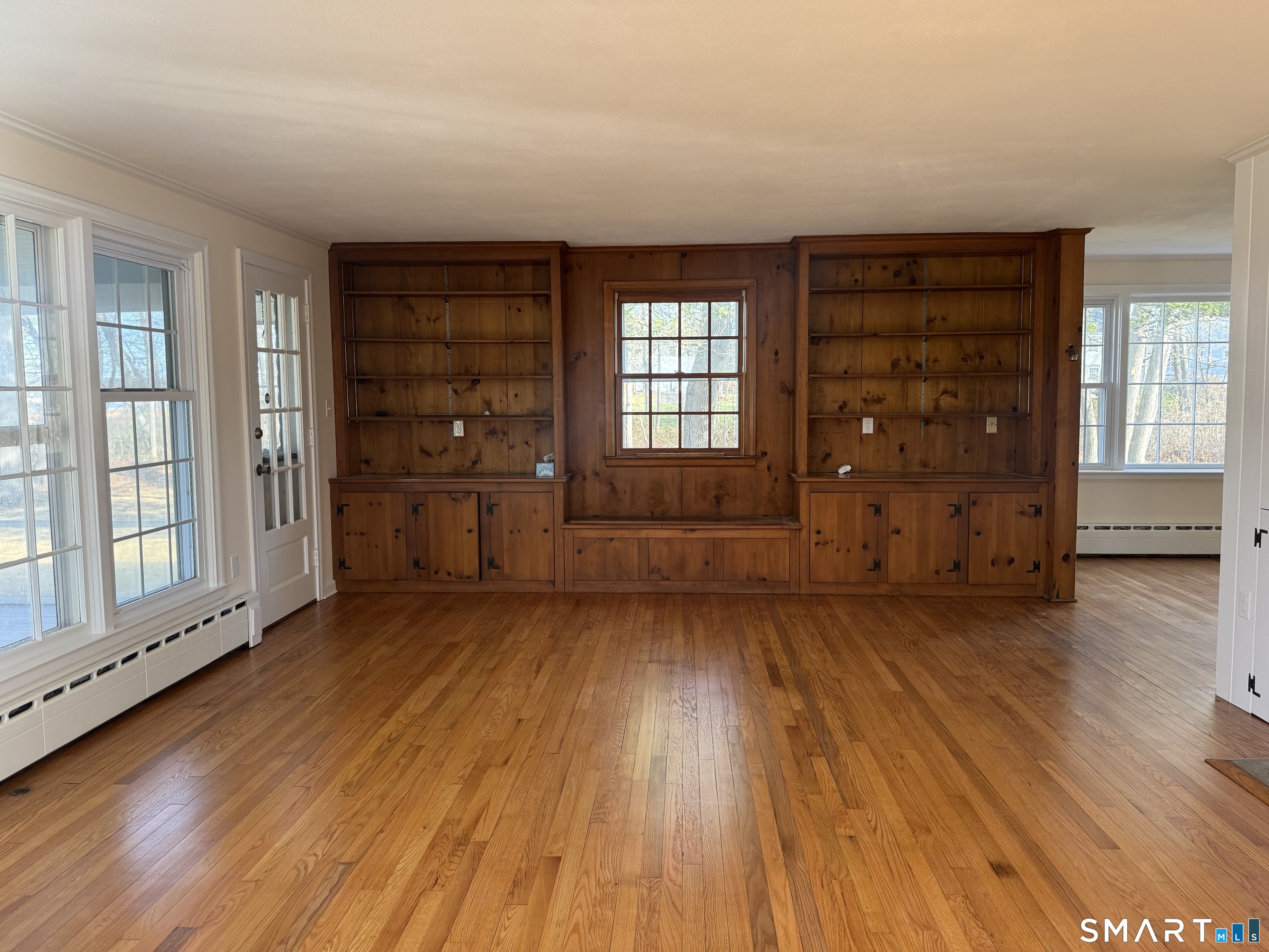 31 Pawson Road Branford, CT 06405 - Photo 8 of 13 wooden floor in an empty room with a window