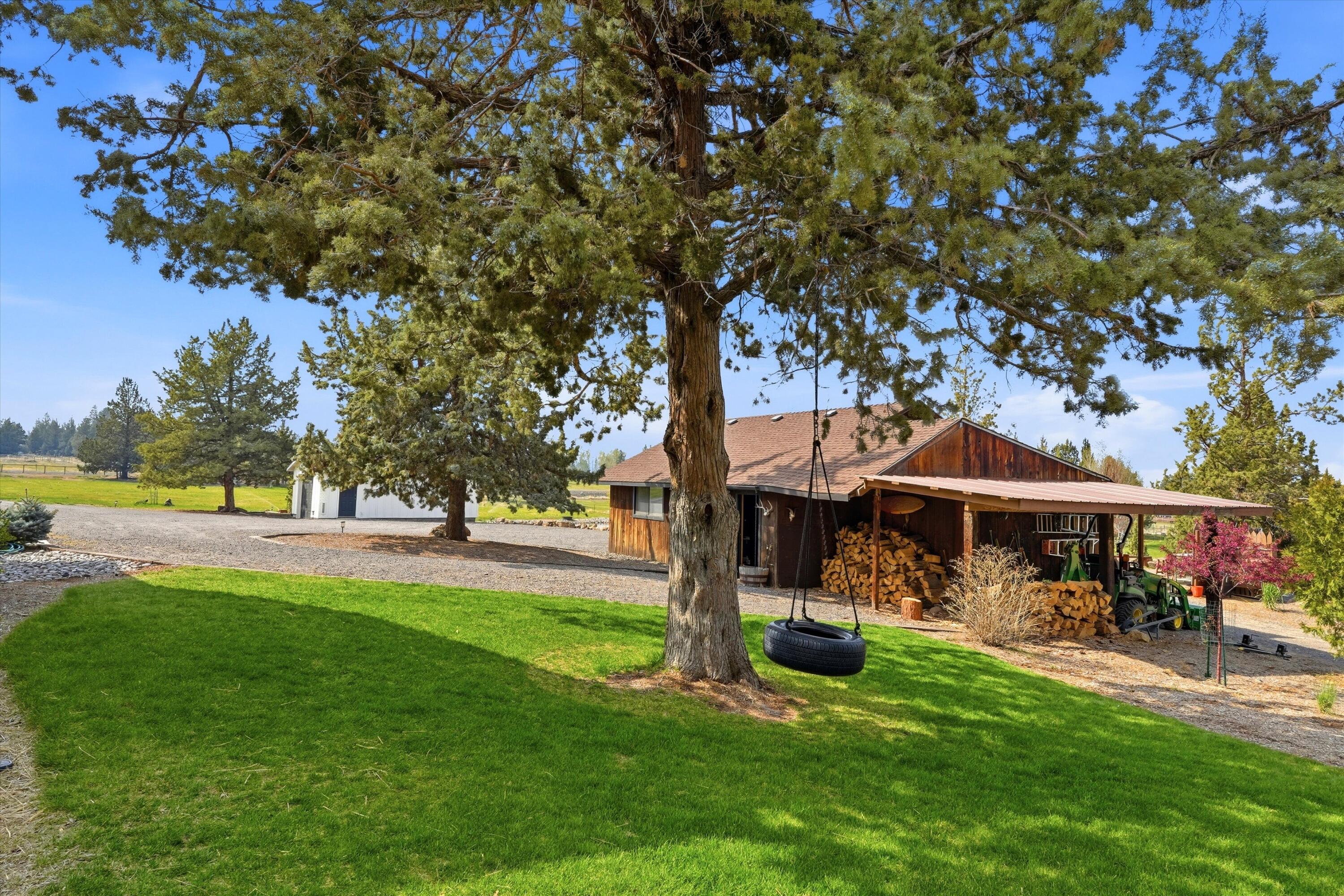 61280 Larsen Road Bend, OR 97702 - Photo 34 of 58 a view of a house with a yard porch and sitting area