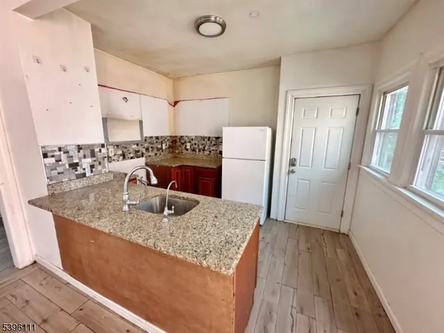 a view of a kitchen counter space and wooden floor