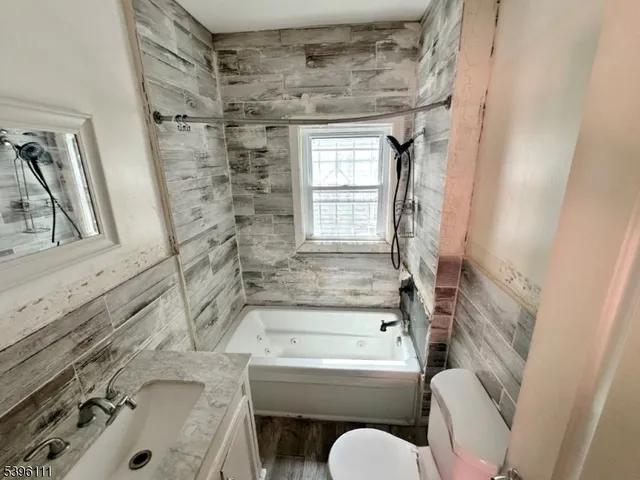 a bathroom with a sink toilet and bathtub