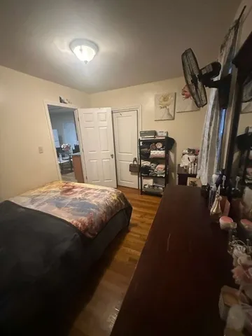 a bed room with a bed and a chair