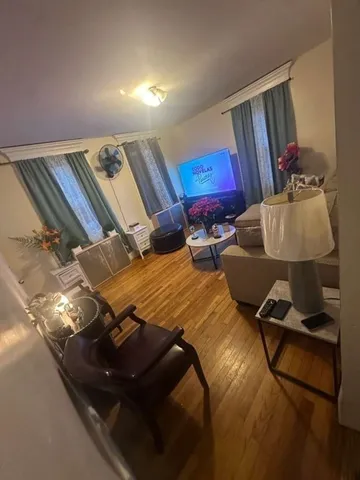 a living room with furniture rug and lamp