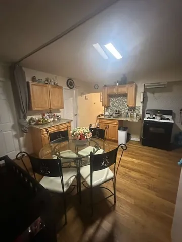 a kitchen with a table chairs stove and cabinets