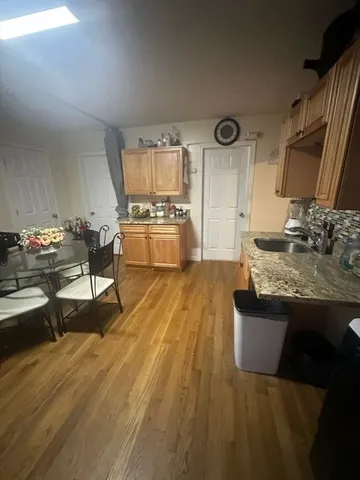 a living room with granite countertop furniture and wooden floor