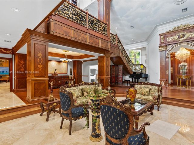 a living room with furniture a piano and a large window