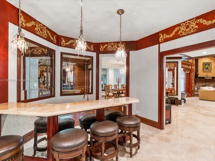 a kitchen with granite countertop a stove and a view of living room