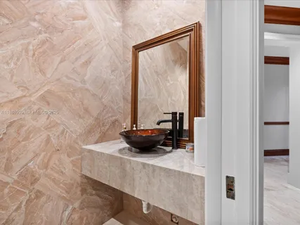 a kitchen with stainless steel appliances granite countertop a sink and a refrigerator