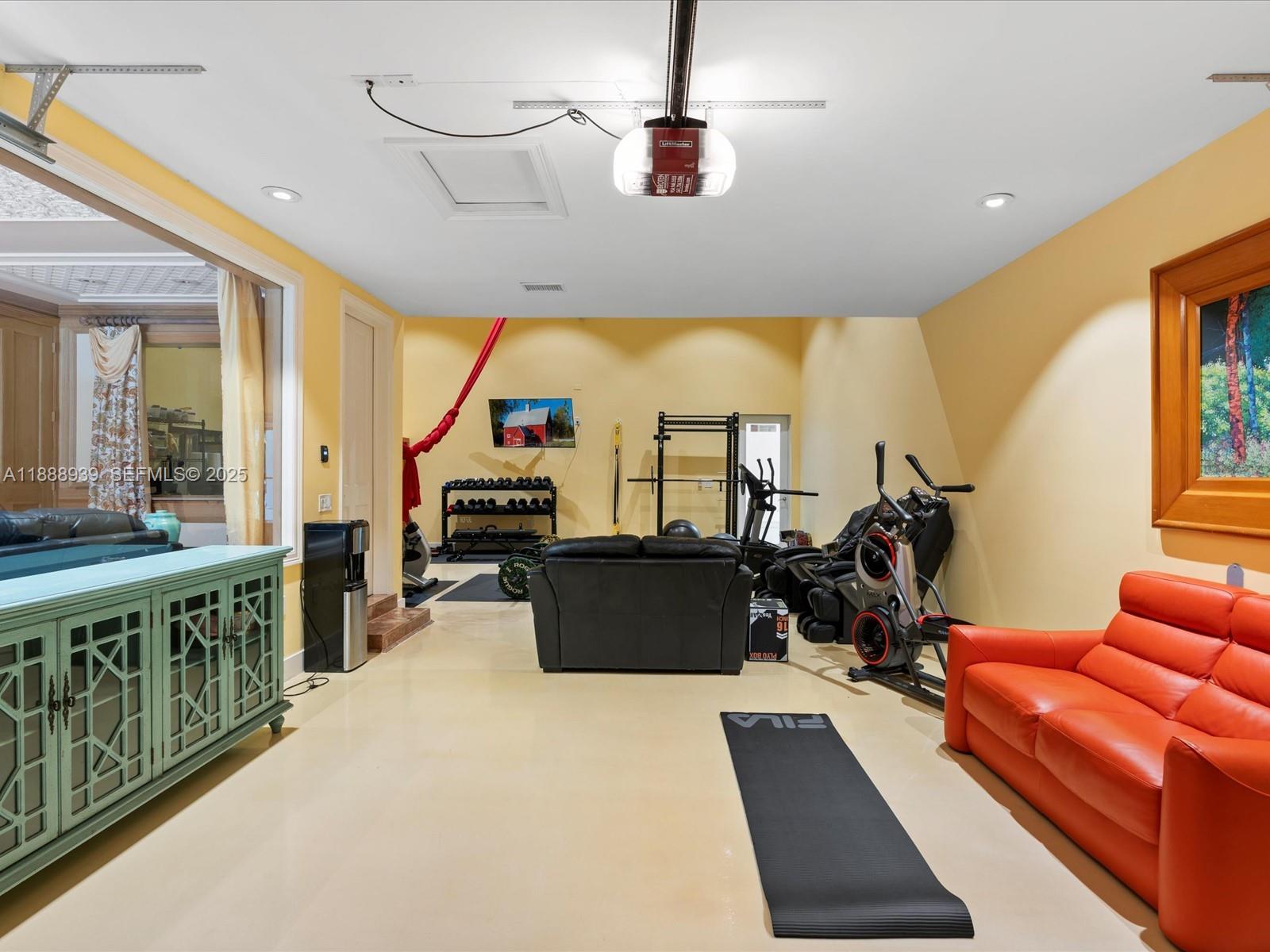 2941 Paddock Lane Weston, FL 33331 - Photo 26 of 90 a living room with furniture gym equipment and a large window