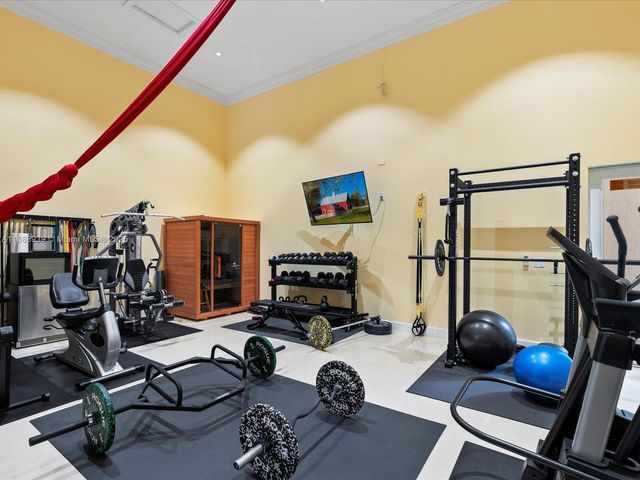 a view of a dining room with furniture a chandelier and large windows