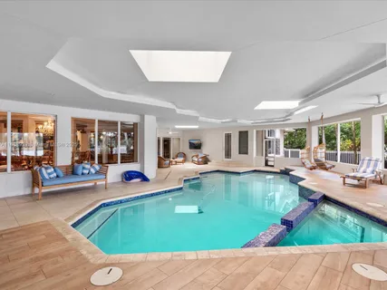 a view of a room with furniture wooden floor carpet and windows