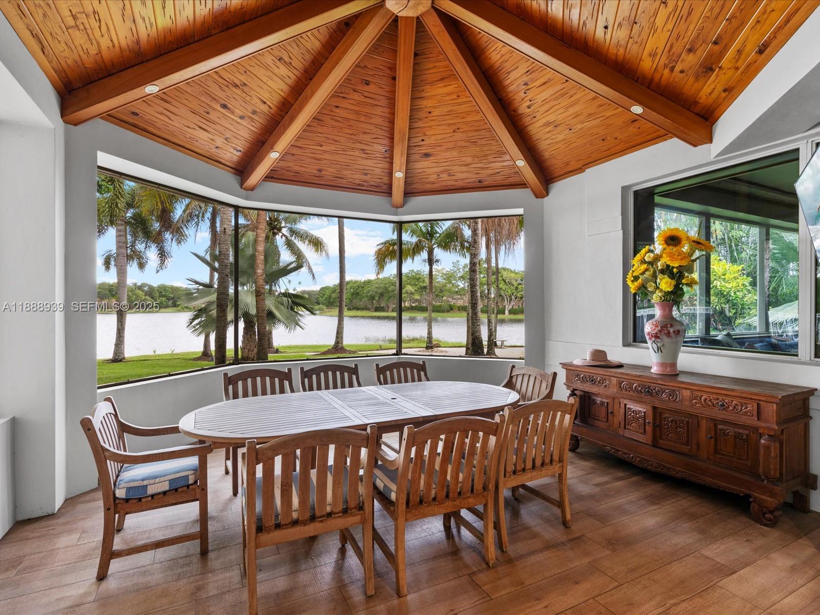 2941 Paddock Lane Weston, FL 33331 - Photo 32 of 90 a dining room with furniture large windows and a chandelier