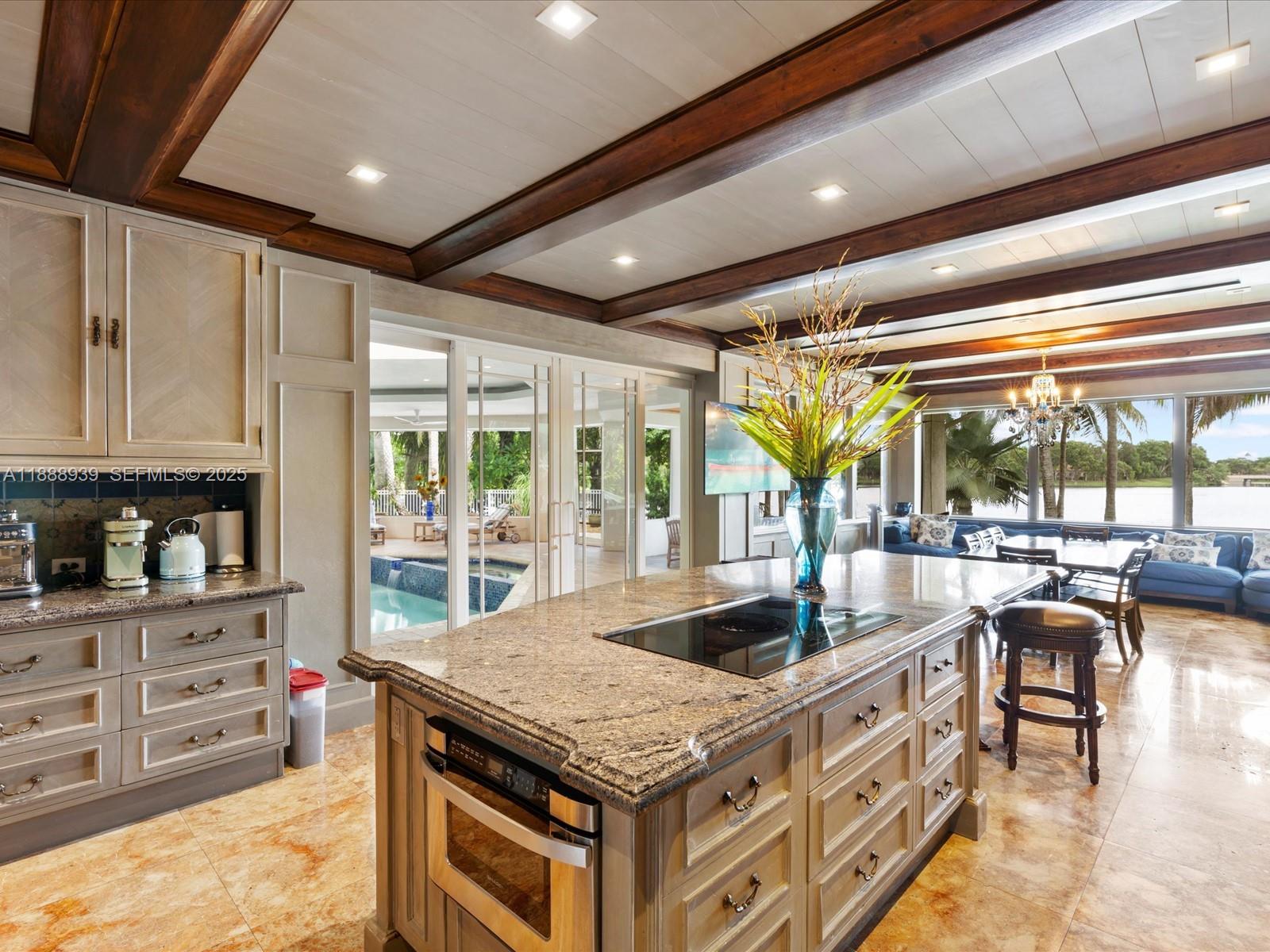 2941 Paddock Lane Weston, FL 33331 - Photo 33 of 90 a kitchen with granite countertop a stove and a view of living room