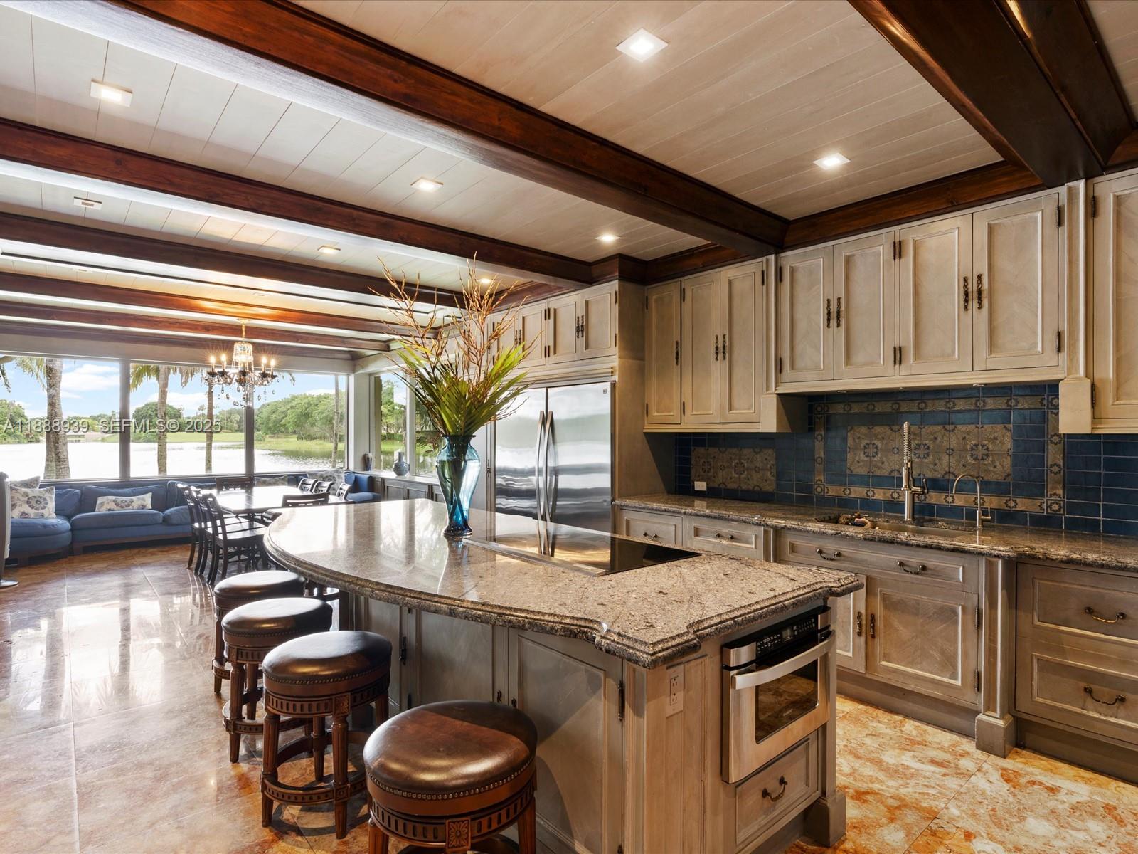 2941 Paddock Lane Weston, FL 33331 - Photo 34 of 90 a kitchen with a stove a sink and a refrigerator