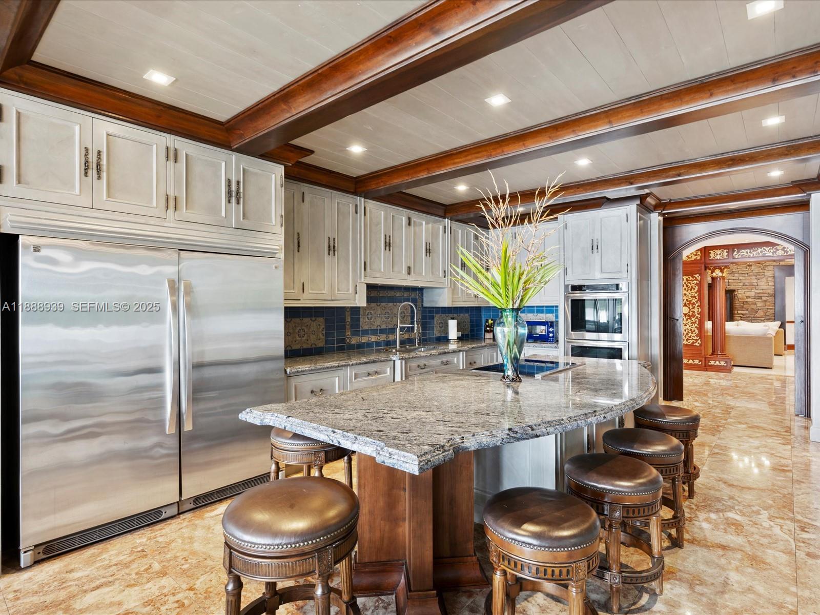 2941 Paddock Lane Weston, FL 33331 - Photo 36 of 90 a kitchen with stainless steel appliances granite countertop a sink and a refrigerator