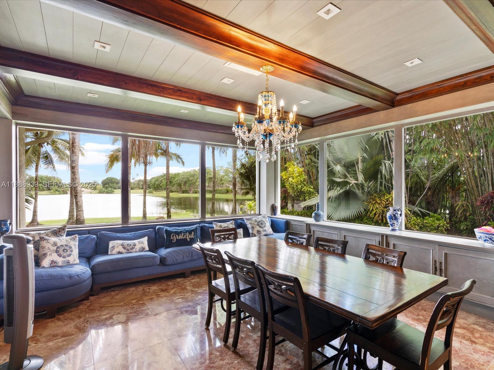 2941 Paddock Lane Weston, FL 33331 - Photo 37 of 90 a view of a dining room with furniture large windows and wooden floor