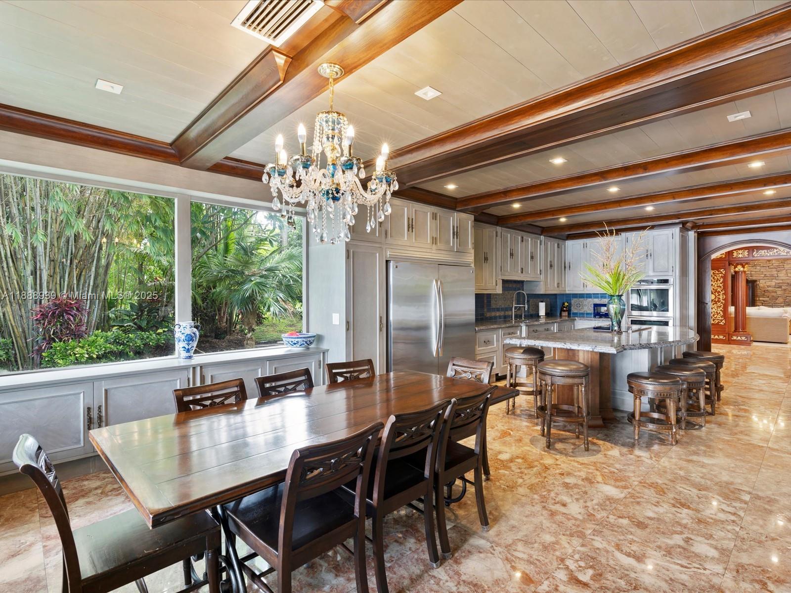 2941 Paddock Lane Weston, FL 33331 - Photo 38 of 90 a dining area with furniture a chandelier and kitchen view