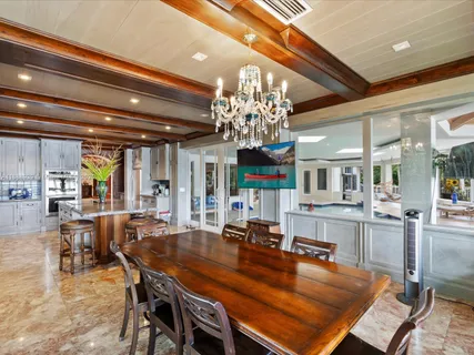 a hallway with white doors wooden floor and a table