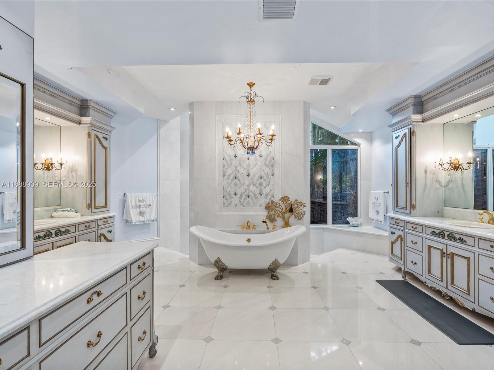 2941 Paddock Lane Weston, FL 33331 - Photo 43 of 90 a spacious bathroom with a sink a large mirror and a bathtub