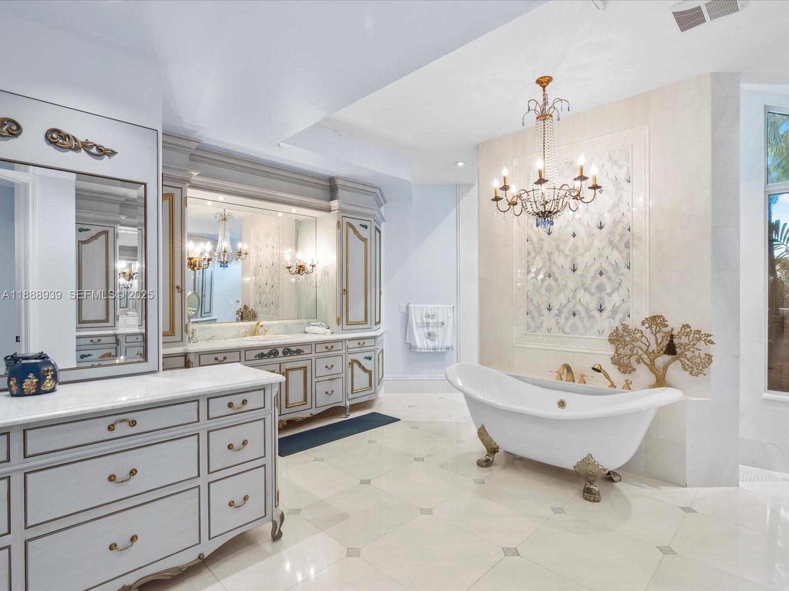 2941 Paddock Lane Weston, FL 33331 - Photo 44 of 90 a spacious bathroom with a double vanity sink mirror and bathtub