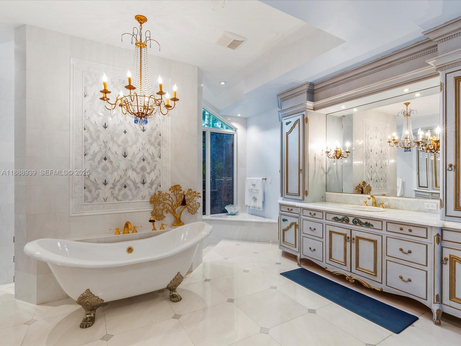 2941 Paddock Lane Weston, FL 33331 - Photo 45 of 90 a spacious bathroom with a tub sink and mirror