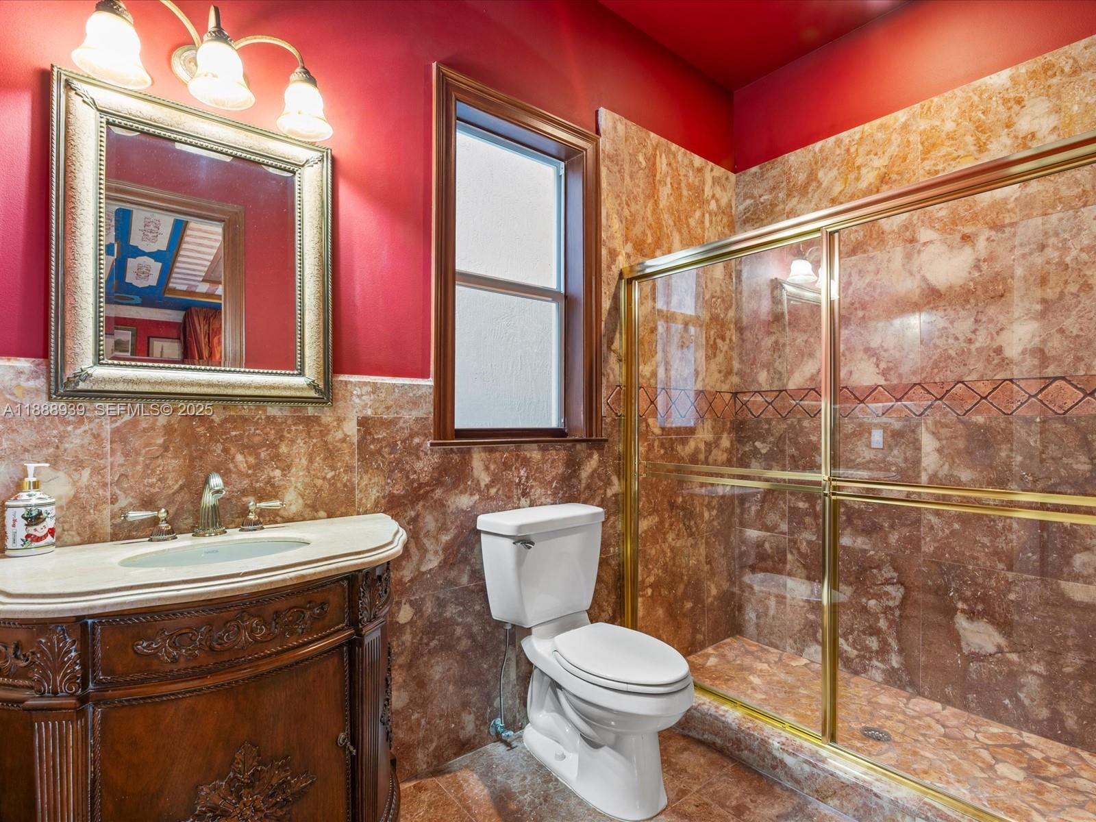 2941 Paddock Lane Weston, FL 33331 - Photo 49 of 90 a bathroom with a sink a toilet and mirror