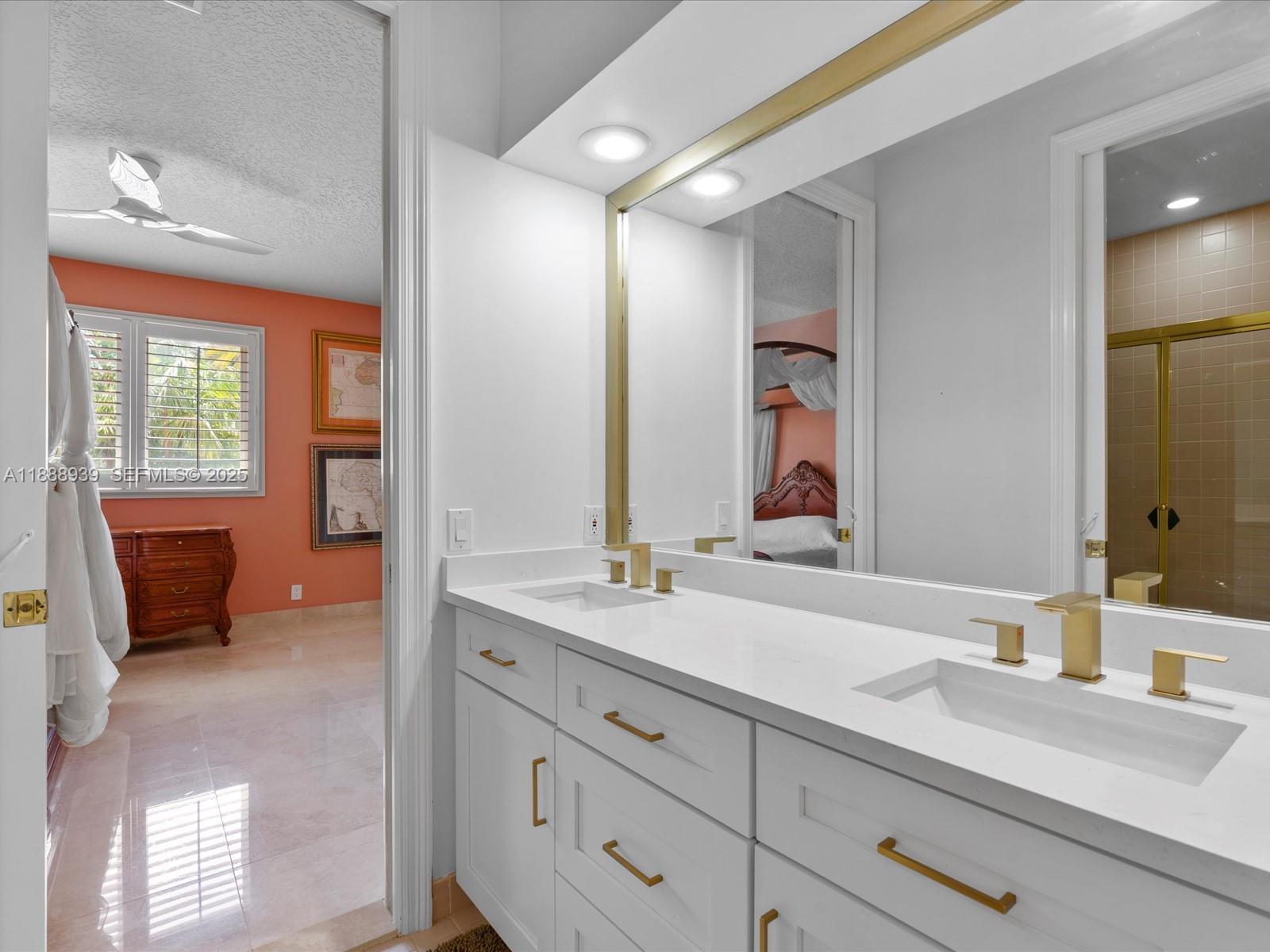 2941 Paddock Lane Weston, FL 33331 - Photo 64 of 90 a en suite bathroom with double sink and a mirror