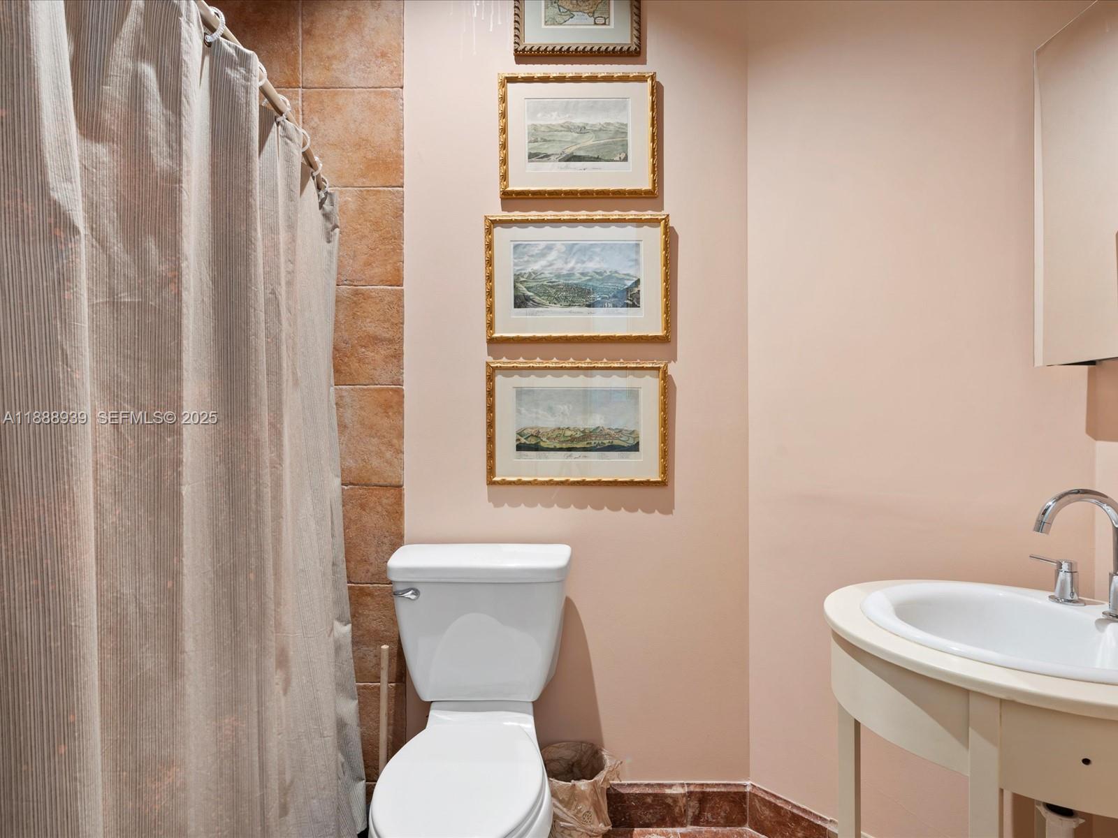 2941 Paddock Lane Weston, FL 33331 - Photo 71 of 90 a white toilet sitting next to a bathroom sink