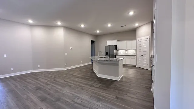 a kitchen with kitchen island a sink stainless steel appliances and cabinets