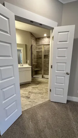 a bathroom with a shower sink and mirror