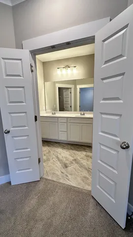 a bathroom with a shower sink and mirror
