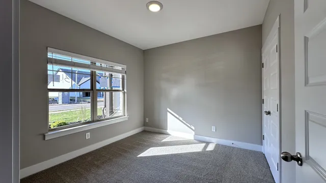 an empty room with windows and closet