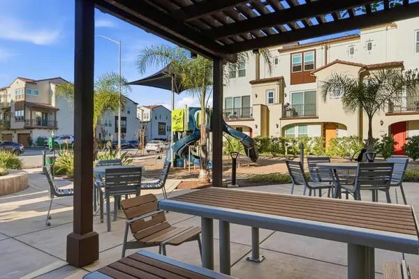 a view of a patio with dining table and chairs with wooden floor