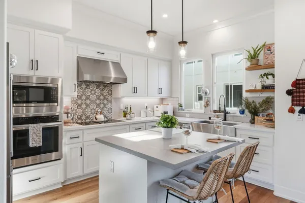 a kitchen with stainless steel appliances kitchen island granite countertop a sink and microwave