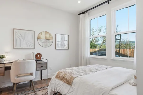 a bedroom with a bed and a window