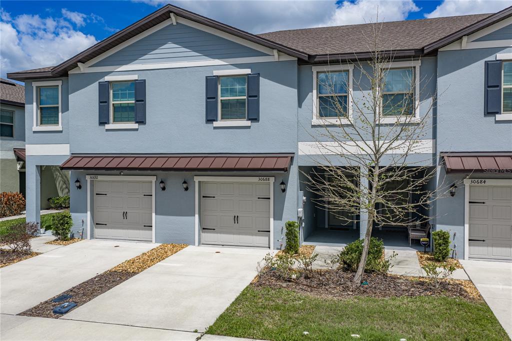 30688 Veridian Way Wesley Chapel, FL 33543 - Photo 1 of 55 a front view of a house with a garage