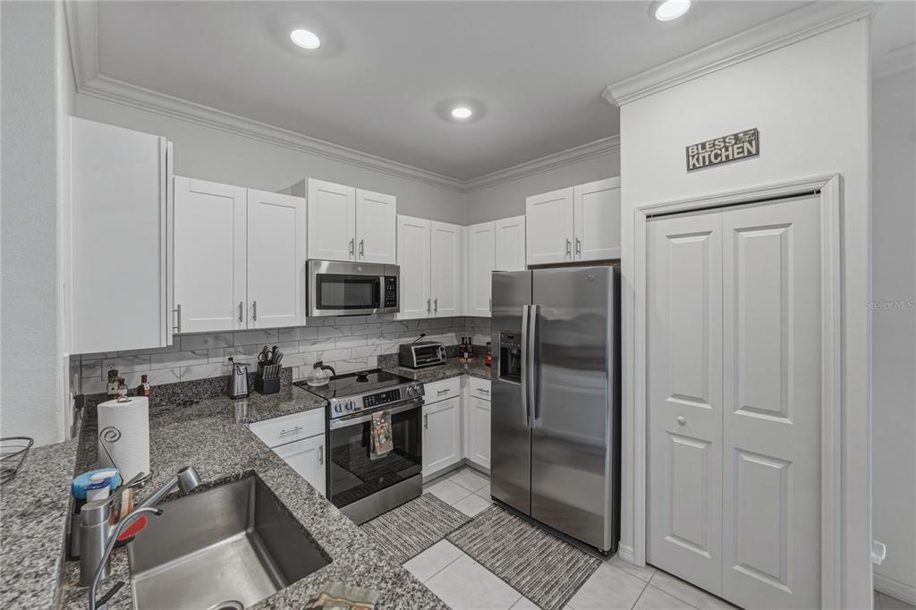 30688 Veridian Way Wesley Chapel, FL 33543 - Photo 12 of 55 a kitchen with stainless steel appliances granite countertop a refrigerator stove and sink