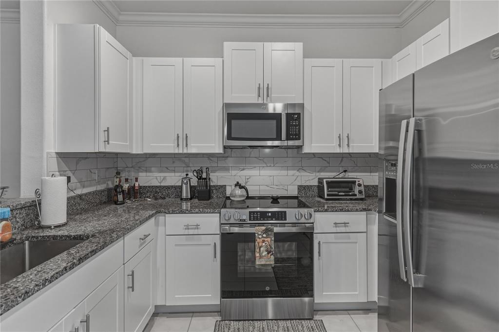 30688 Veridian Way Wesley Chapel, FL 33543 - Photo 13 of 55 a kitchen with appliances a sink and cabinets