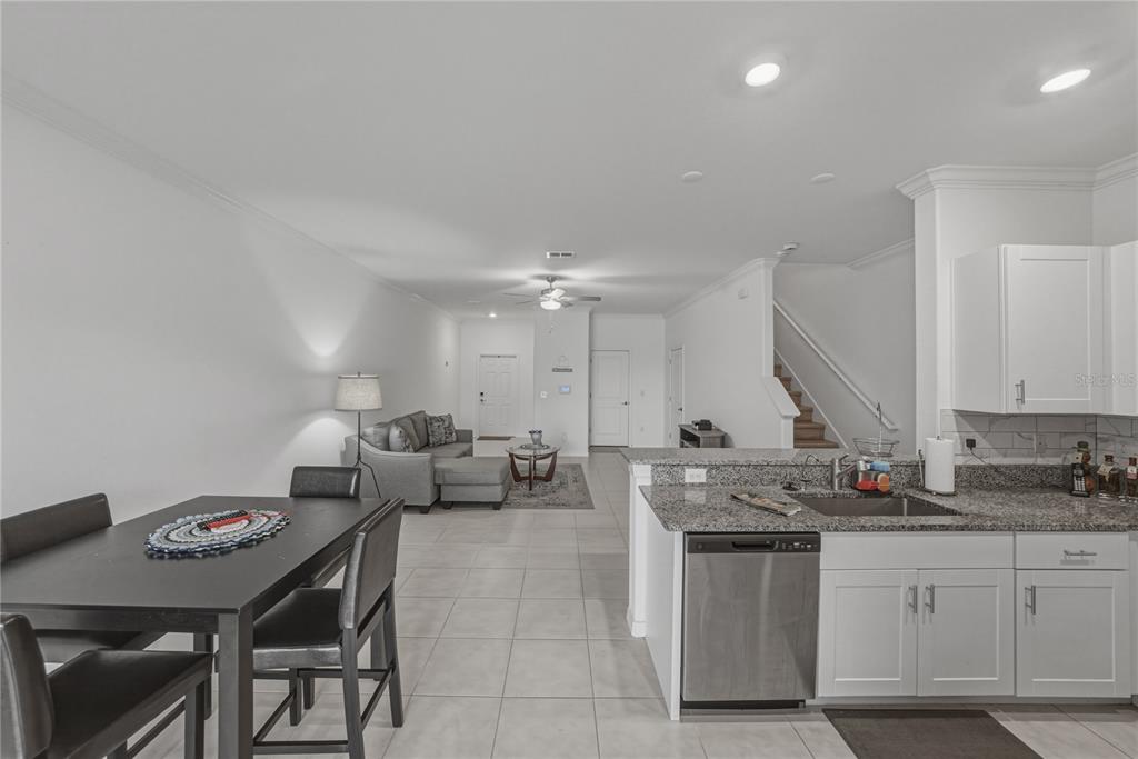 30688 Veridian Way Wesley Chapel, FL 33543 - Photo 15 of 55 a open kitchen with stainless steel appliances granite countertop a sink a stove a dining table and chairs