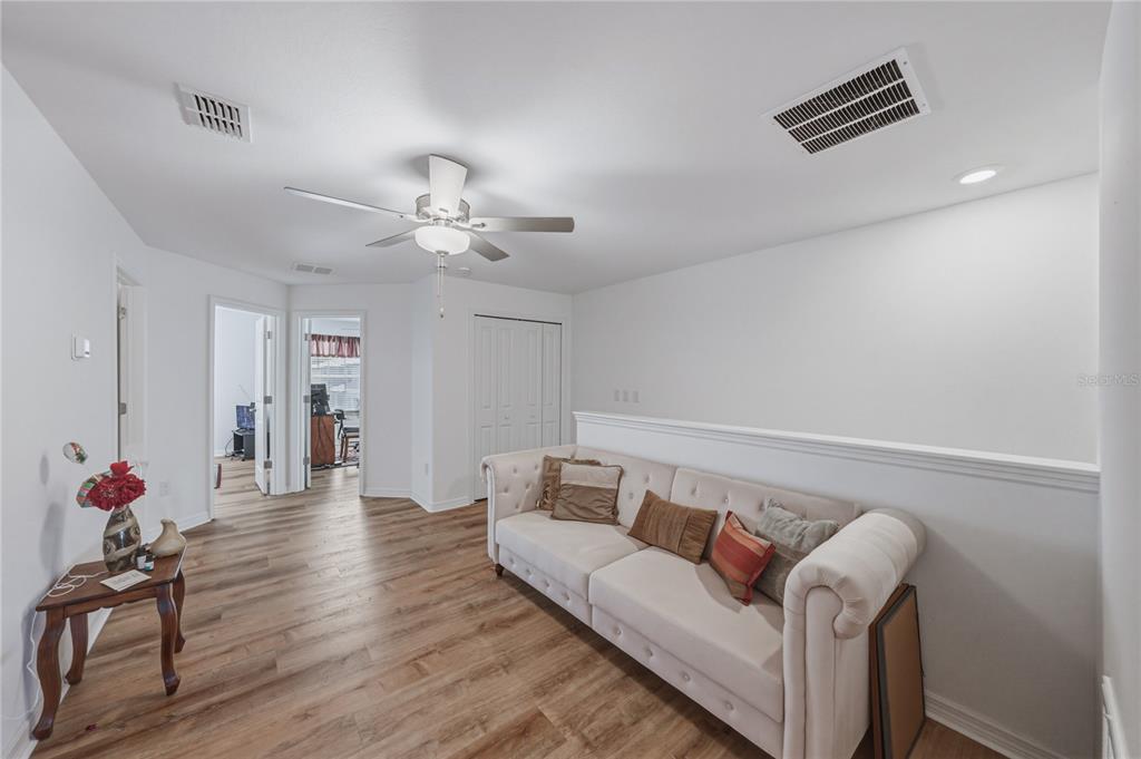 30688 Veridian Way Wesley Chapel, FL 33543 - Photo 20 of 55 a living room with furniture and wooden floor