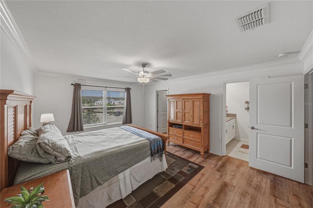 30688 Veridian Way Wesley Chapel, FL 33543 - Photo 25 of 55 a bedroom with a bed and wooden floor