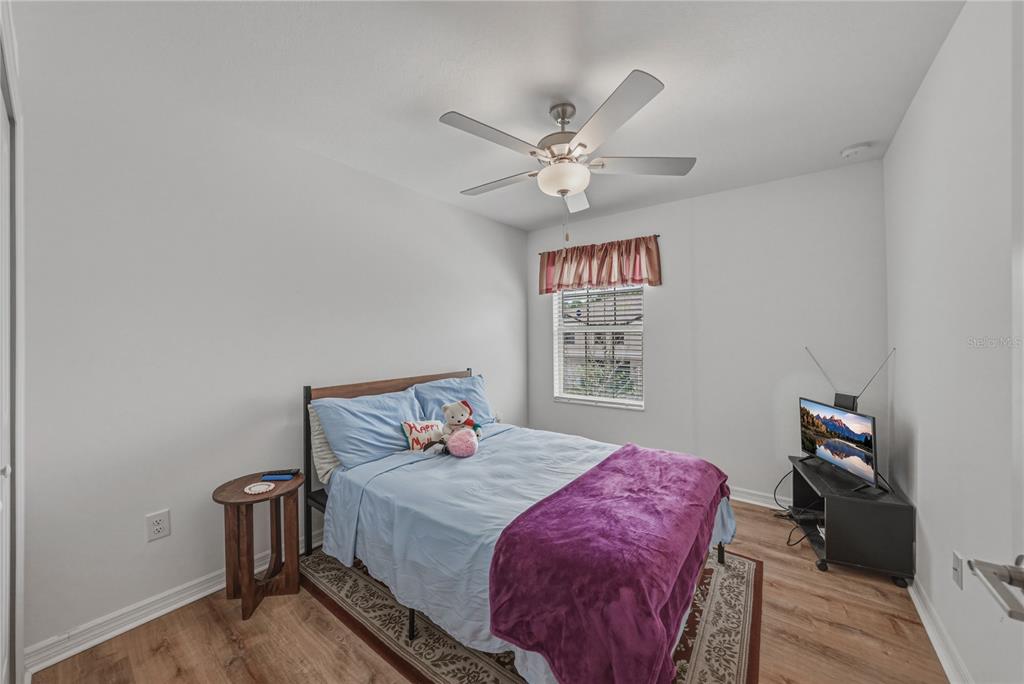 30688 Veridian Way Wesley Chapel, FL 33543 - Photo 32 of 55 a bedroom with a bed and a chandelier