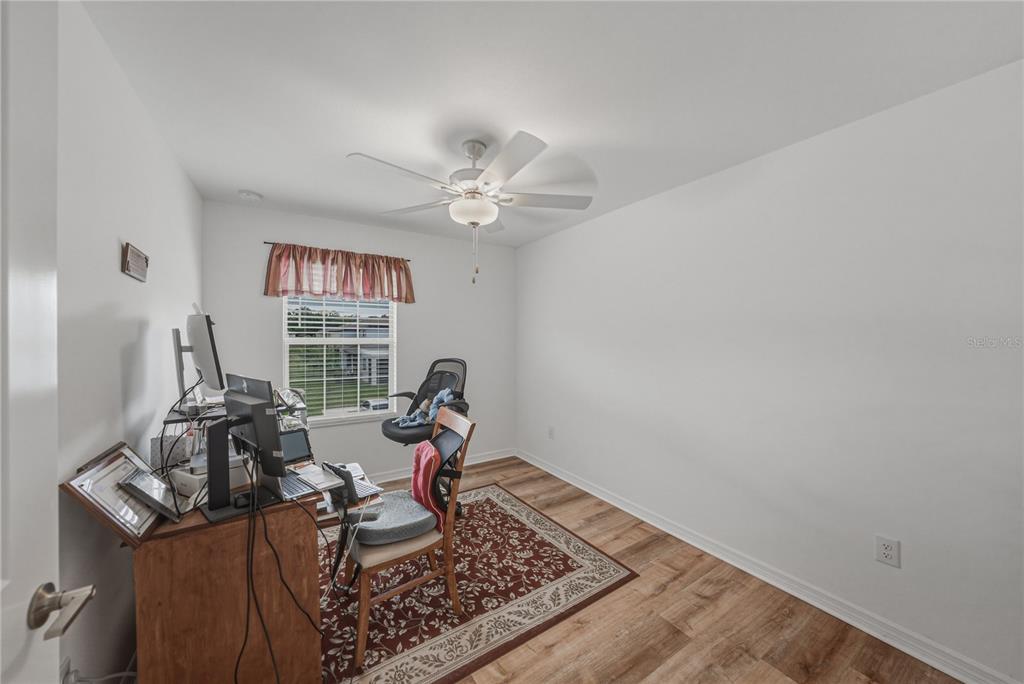 30688 Veridian Way Wesley Chapel, FL 33543 - Photo 34 of 55 a living room with furniture and a chandelier