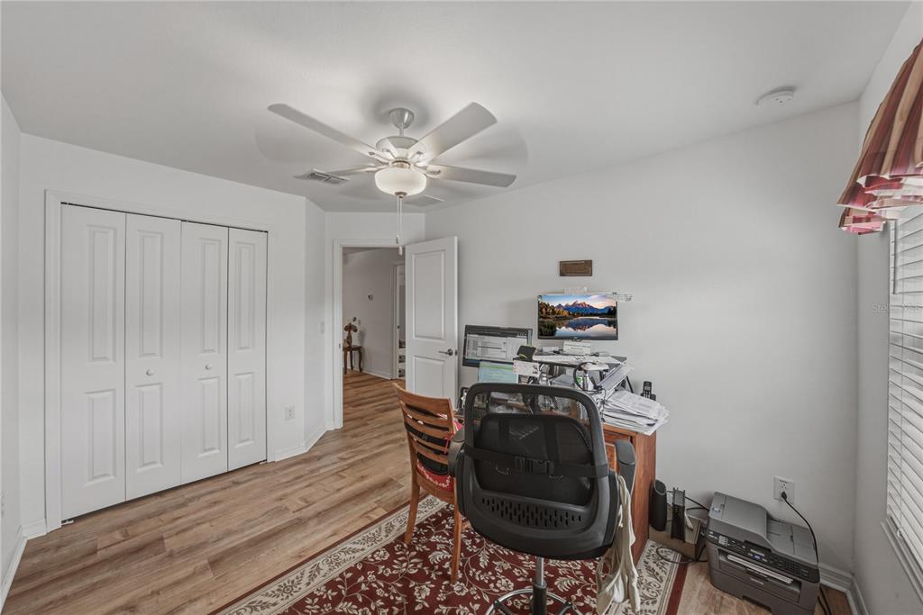 30688 Veridian Way Wesley Chapel, FL 33543 - Photo 36 of 55 a living room with furniture and a wooden floor
