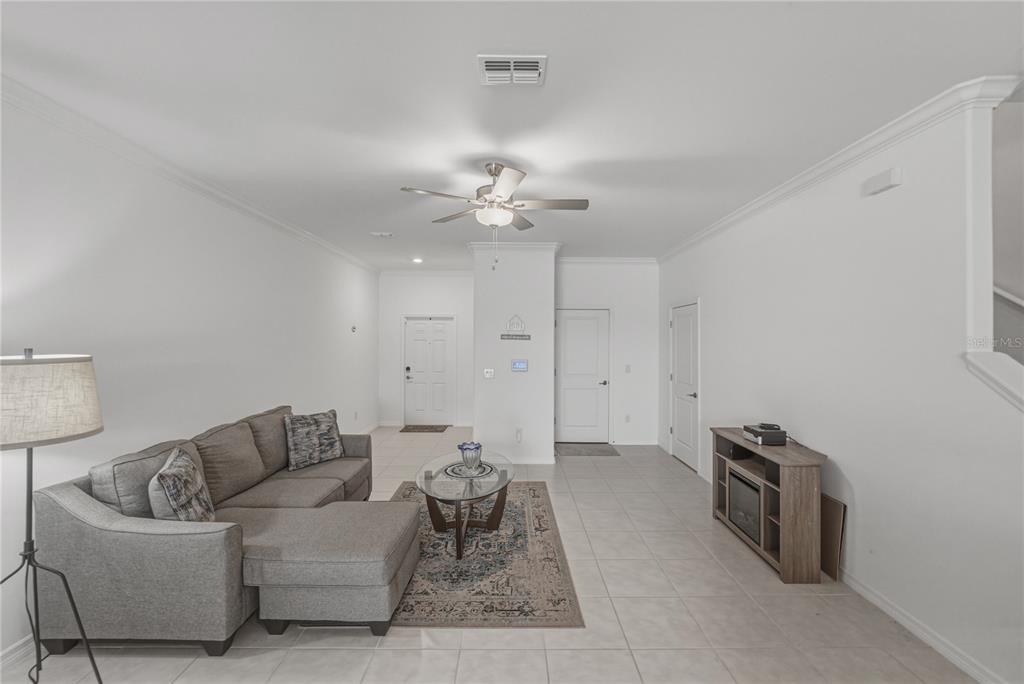 30688 Veridian Way Wesley Chapel, FL 33543 - Photo 7 of 55 a living room with furniture and a chandelier