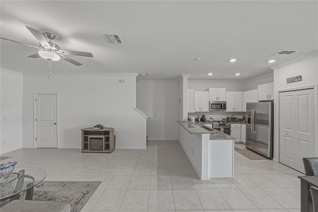 30688 Veridian Way Wesley Chapel, FL 33543 - Photo 8 of 55 a kitchen with stainless steel appliances granite countertop a refrigerator a stove a sink a washer and dishwasher