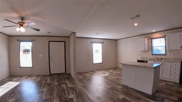 a view of a room with window hardwood floor and a ceiling fan